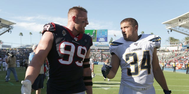 Houston's J.J. Watt (99) and brother Derek Watt of Los Angeles walk off the field following the Texans' 27-20 victory over the Chargers at Dignity Health Sports Park on Sept. 22, 2019, in Carson, California.